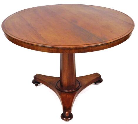 A Victorian mahogany breakfast table, the circular top with a plain outline on a shaped stem terminating in a tricorn base, with compressed double bun feet, 76cm high, 99cm diameter.