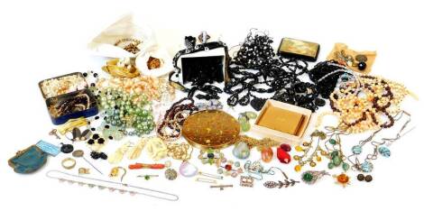 Various jet style and other costume jewellery, necklaces, brooch 6cm wide, various beads, amber coloured glass necklace, Edwardian ivory brooches, other Edwardian brooches, two powder compacts, etc. (a quantity)