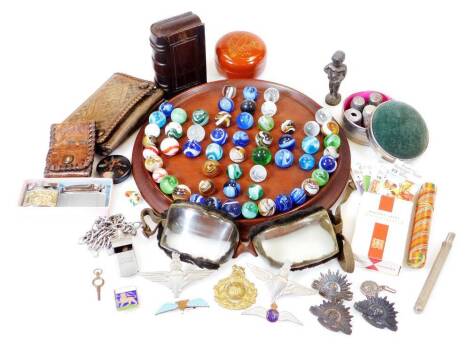 Bygones collectables, etc., a solitaire board with marbles, E initialled leather purse 10cm wide, treen book snuff box, pin cushion, thimbles, goggles, cap badges, etc. (a quantity)