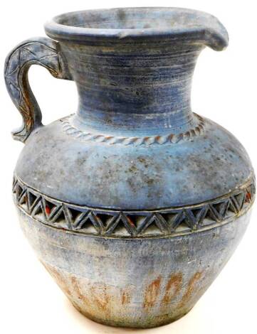 A 20thC pottery Roman style ewer, of large proportion with lid top, tapering body raised with a geometric banding and plain handle, 58cm high.