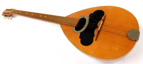 An early 20thC bouzouki, with elongated arm and shaped body with partial inlay and partially ebonised top, with eight tuning knops, 101cm high.