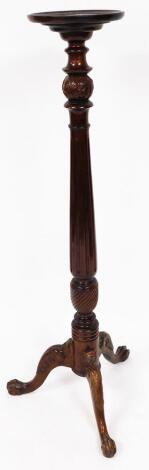 An early 20thC mahogany plant stand, the moulded circular top raised on an acanthus and fluted tapering stem terminating in acanthus capped triple cabriole legs with scroll feet, 122cm high, 27cm diameter.