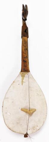 A 20thC African tribal musical instrument, with single string and springbok style head, with plain tear shaped body, 84cm high.