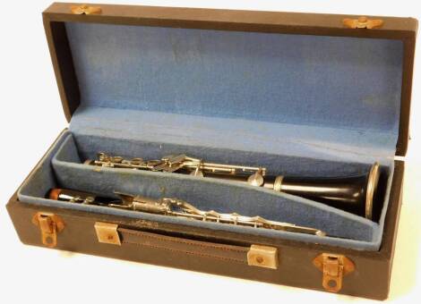 A 20thC Martin Freres French three piece clarinet, with additional mouthpiece, partially ebonised with chrome mounts, in fitted case, the case 39cm wide.