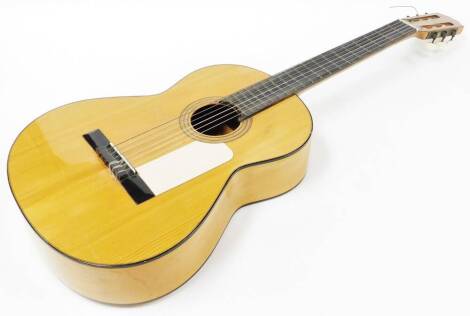 A 20thC Alhambra S A Spanish six string guitar, with shaped body and six tuning knops, 100cm wide.