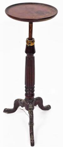 An early 20thC mahogany plant stand, the circular top raised on a reeded stem, terminating in heavily carved triple cabriole legs, 90cm high, the top 30cm diameter.