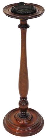 An early 20thC mahogany smokers stand, the circular top with removable section on a elongated baluster stem and circular foot, 61cm high, the top 17cm diameter.