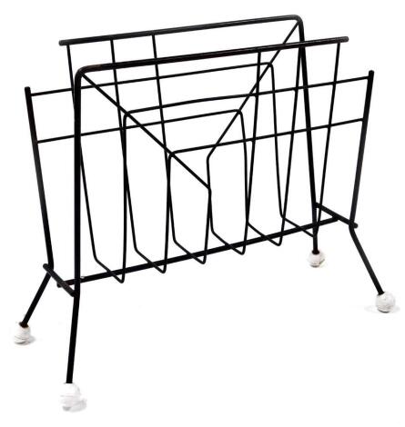 A retro wirework newspaper rack, on orb feet, 36cm high, 48cm wide, 17cm deep.