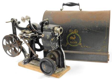 An early 20thC Pathe KOK 28mm projector, with articulated handle, with metal frame on pine base with tin cased top, 43cm high.