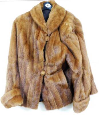 An early 20thC ladies fur coat, quarter length with lining, in brown, size unknown.