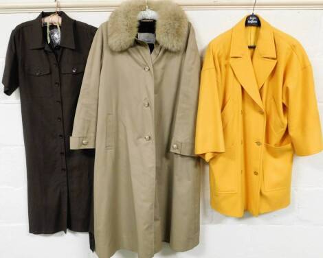 An Aquascutum of London Firenze vintage ladies coat, three quarter length with fur collar, and a further yellow coat and shirt.