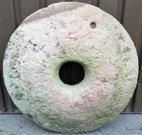 A large mill stone, of domed form, with central circular opening, 110cm diameter.