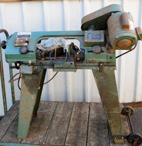 A Spaldings free standing metal bandsaw, serial number 977527, 99cm high.