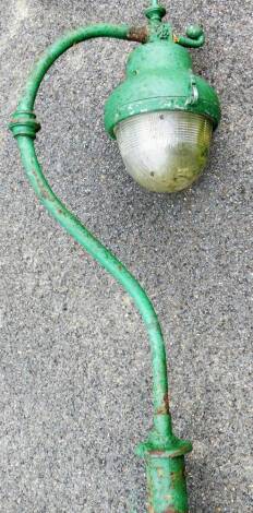 A 20thC cast iron free standing street light, the shaped bulb in domed casing, on a hook style fastening and cylindrical stem, approx 355cm high.