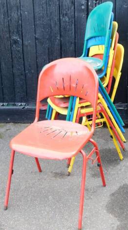 A set of six painted metal stacking chairs, with pierced backs and seats, 95cm high.