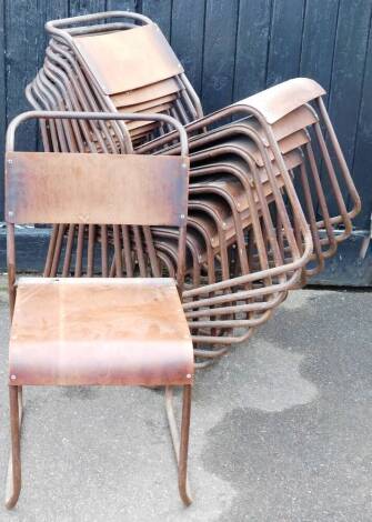 A set of eleven bent metal stacking chairs, with shaped wooden backs and seats, 83cm high.