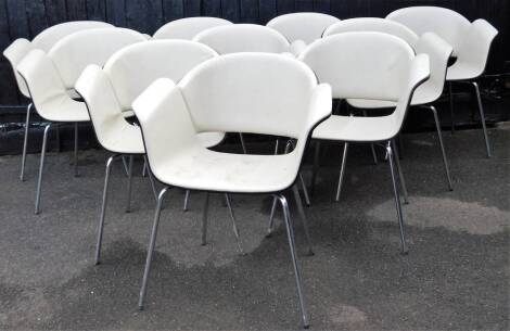 A set of ten Bene retro chairs, with cream arms and seats, on shaped chrome legs, label beneath, 82cm high.