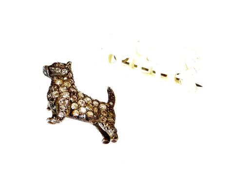 An early 20thC terrier brooch, set with small white diamonds, the eyes picked out in red stones, unmarked, 3cm high. (AF)