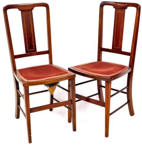 A pair of Edwardian mahogany and boxwood strung salon chairs, each with overstuffed seats on square tapering front legs, joined by horizontal stretchers, 85cm high.