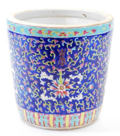 A 20thC Chinese famille bleu planter, of tapering cylindrical form, decorated with flowers on a blue ground with a turquoise banding, 21cm high, 22cm diameter.