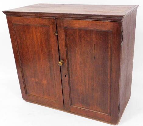 A 19thC oak cupboard, of rectangular form with panelled doors, shelves to the interior, 91cm high, 105cm wide, 51cm deep.