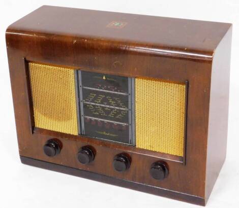 A mid 20thC Bush walnut cased radio, type AC II, with four front Bakelite tuning knops with a mesh front speaker, 40cm high, 50cm wide, 21cm deep.