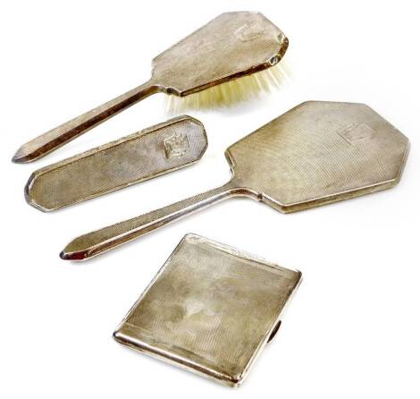 A George V silver cigarette case, of rectangular form, partially engine turned with thumb mould handle and plain interior, Birmingham 1936, 10cm wide, 5oz and a three piece silver part dressing table set. (a quantity)