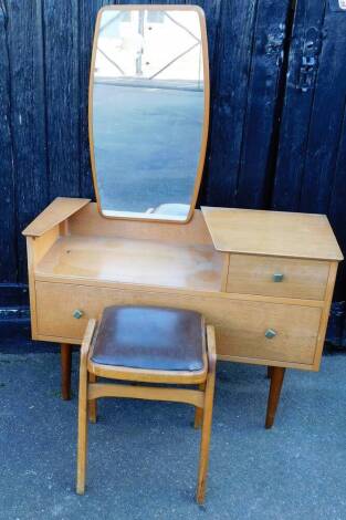 A 20thC retro teak mirror back dressing table, with one short and one long drawer, on turned legs, 144cm high, 97cm wide, 43cm deep, and a leather topped stool.