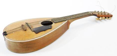 A 20thC La Foley seven string mandolin, of shaped form, with eight tuning knops, with London label, 60cm wide.