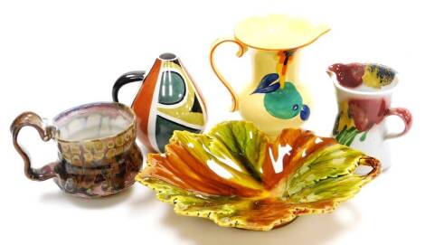 A Schramberg Majolica leaf shaped dish, with moulded handle, impressed mark beneath, 25cm wide, a Devon ware Art Deco jug, globular Studio vase, cup with shaped handle, and a further inverted Studio jug. (a quantity)