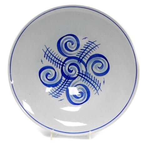 An early 1930's Susie Cooper plate, of circular form, with a swirl design, signature mark and number 545, with impressed number 73 beneath, 23cm diameter.