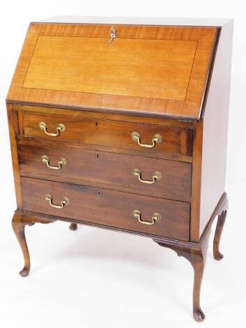 A 20thC mahogany bureau, the fall held by loafers, with a wide cross banding, revealing a drawer and pigeon holes, raised above three long drawers, on cabriole legs, terminating in pad feet, 105cm high, 65cm wide, 49cm deep.