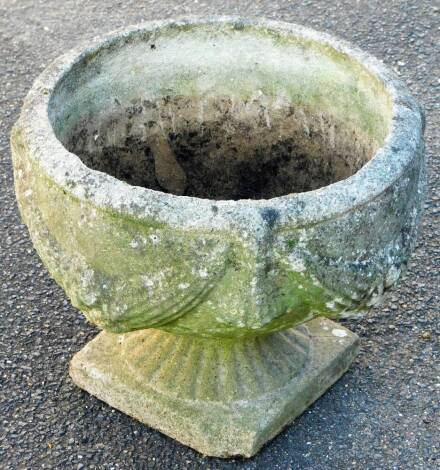 A late 20thC classical design urn, raised with garlands on an inverted stem and sqaure foot, 34cm high, 38cm diameter.