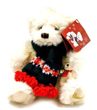 A Harrods plush jointed teddy bear, in white, wearing scarf with label to the ear, 26cm high.