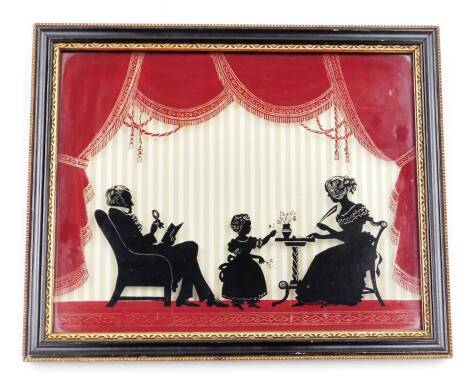 An early 20thC glass silhouette picture, formed as lady and gentleman with child, before curtains, 80.5cm x 23cm, in a Hogarth style frame.