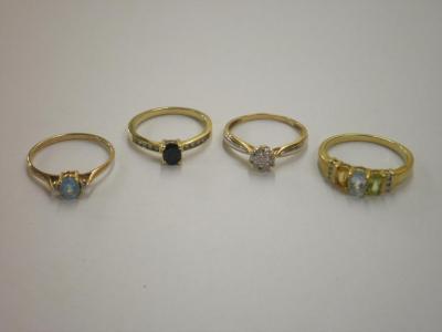 Four 9ct gold stone set rings