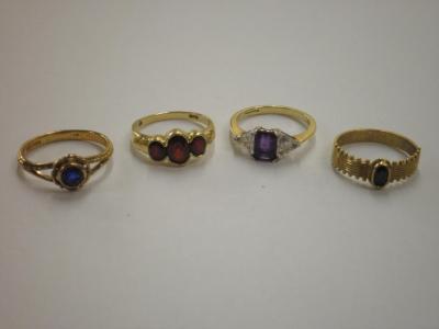 Four 9ct gold stone set rings