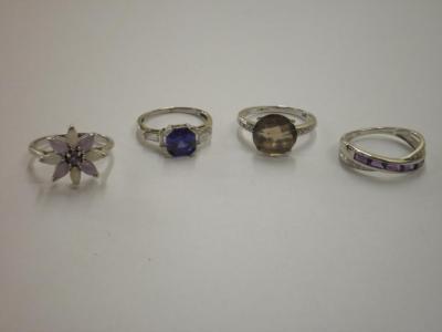 Four 9ct gold stone set rings