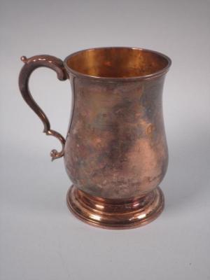 A George IV silver baluster shaped mug with a scroll handle and domed foot<br