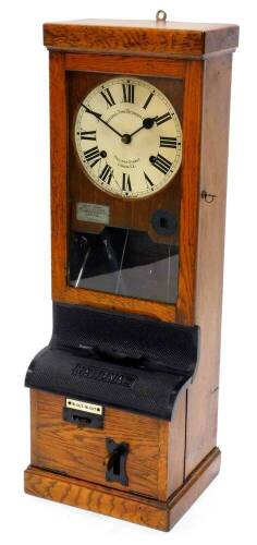 A National Time Recorder Company clocking in clock, the painted dial with Roman numerals in an oak case with bronzed iron fittings, 97cm high, 34cm wide.