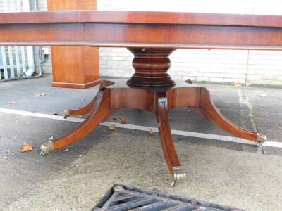 A high quality mahogany 'Jupe' style extending dining table in Regency manner by Arthur Brett of Norwich, model 19231, the circular top inlaid with a central star and with radiating veneers, with concave leaf extensions on a large bulbous turned column, a - 4