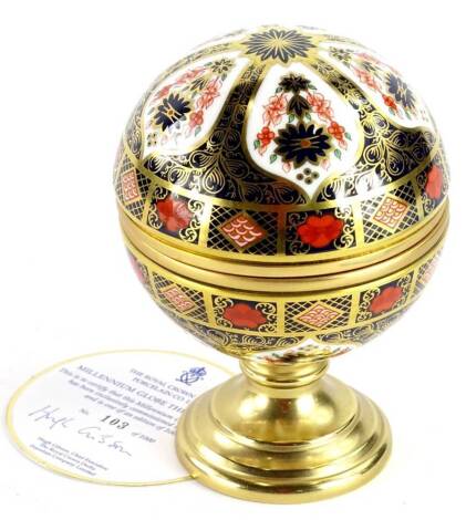 A Royal Crown Derby porcelain Millennium globe thermometer, the hinged lid decorated with the motto, The Clouds Shall Not Reap etc, impressed marks to underside for the factory and the retailers Sinclairs number 105 of 1000 with certificate.