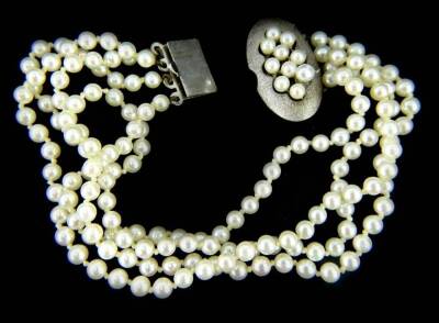 A four row cultured pearl bracelet, with oval silver clasp set with cultured pearls, 19cm long overall.