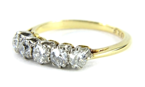 A five stone diamond ring, set with five old cut diamonds, each in claw setting, approx 0.45cts overall, in platinum setting, on a yellow metal band, unhallmarked but marked WM 1925, ring size H, 2.3g all in.