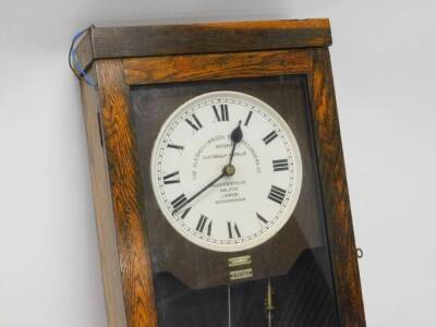 A Gledhill-Brook time recorder, the white painted dial with Arabic numerals in oak case with lockable lower section, keys etc, 114cm high, 40cm wide. - 2