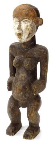 Tribal Art. An African female fertility figure, the face part stained red and painted in white, 62cm high.