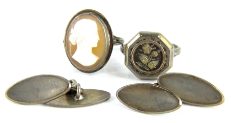 Three items of jewellery, comprising a silver headed dress ring, on a silver plated band, a pair of silver cufflinks and a silver and cameo dress ring.