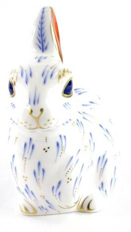 A Royal Crown Derby snowy rabbit paperweight ornament, designed by June Branscombe, faceted gilt stopper, 10cm high.