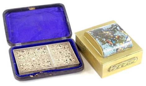 A highly elaborate early 20thC white metal filigree card case, of rectangular form set with flowers in an outer geometric banding, 10cm high, in fitted case, and a Chinese brass box with polished domed partially enameled top. (2)