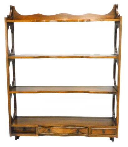 A mahogany wall shelf, with pierced sides and three small drawers, 69cm wide.